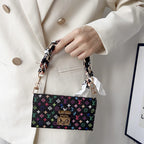 Multicolor LV style iPhone case showing the crossbody strap and protective camera area