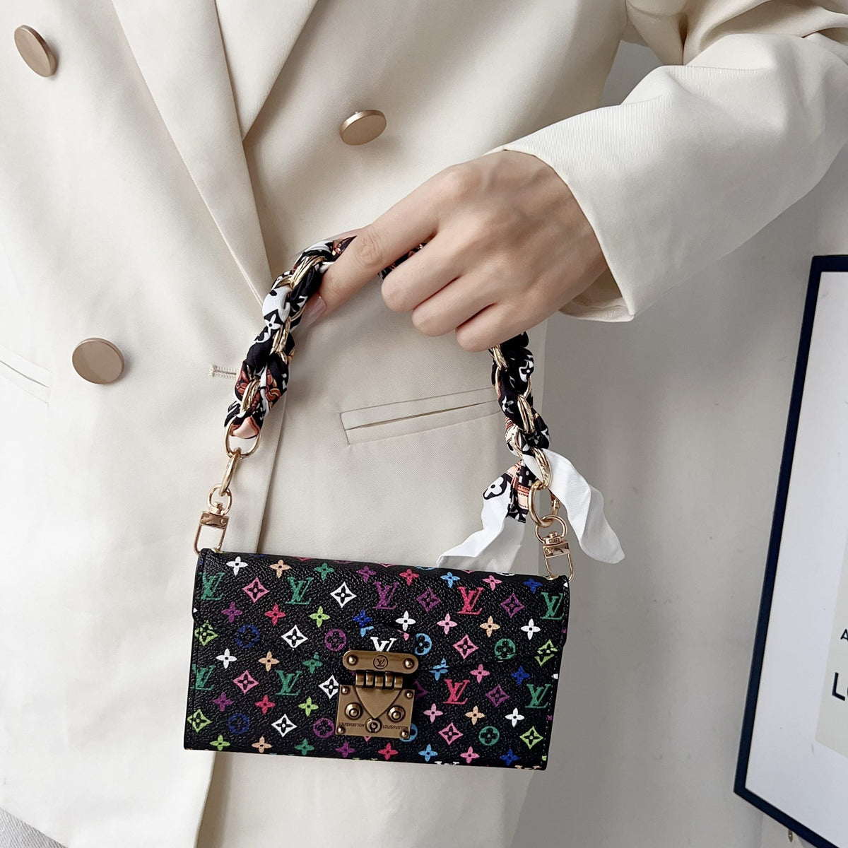 Multicolor LV style iPhone case showing the crossbody strap and protective camera area