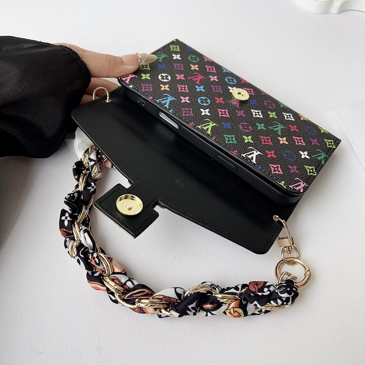 Detailed view of the multicolor crossbody iPhone case showing leather texture and edges