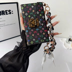 Multicolor crossbody iPhone wallet case shown with the shoulder strap for hands-free carry