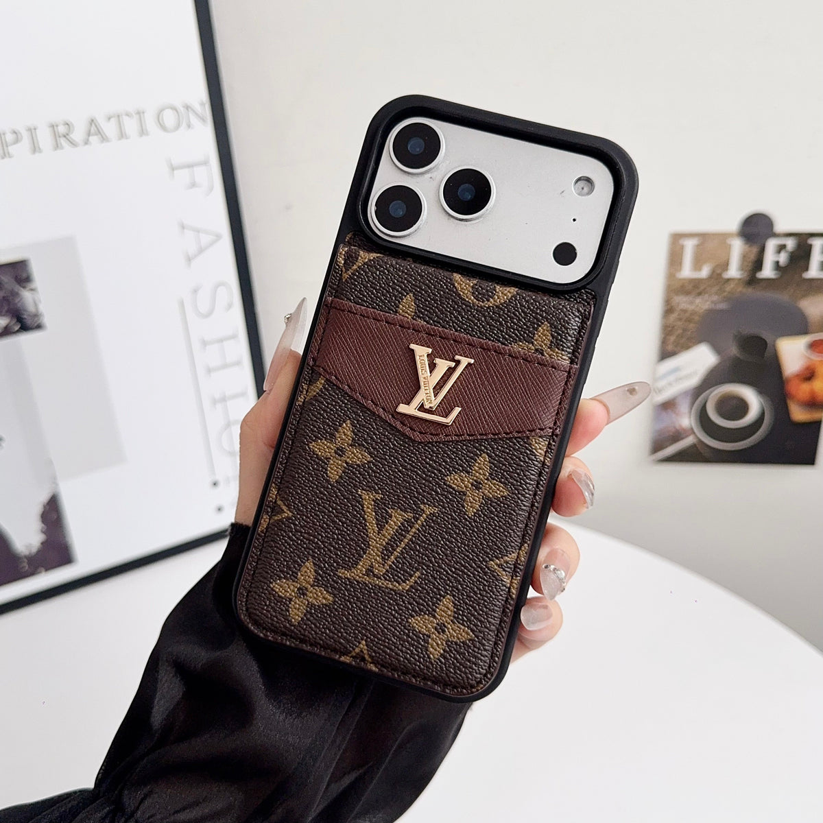 Louis V vertical folding card holder iPhone case shown open with the wallet section visible