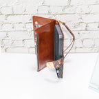 Zippered LV wallet iPhone case showing the leather texture and protective edges