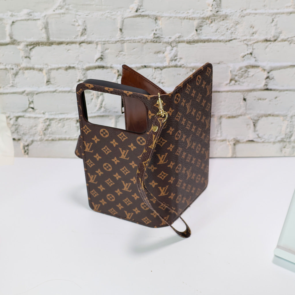 Zippered LV wallet iPhone case close-up showing the patterned leather finish and zipper