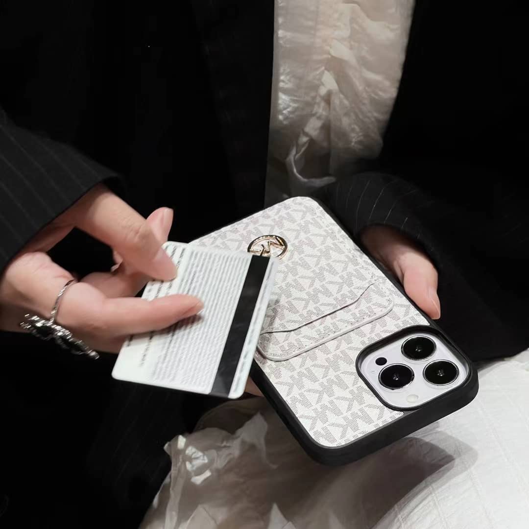 Close-up of the MK iPhone case highlighting the card slot and leather texture