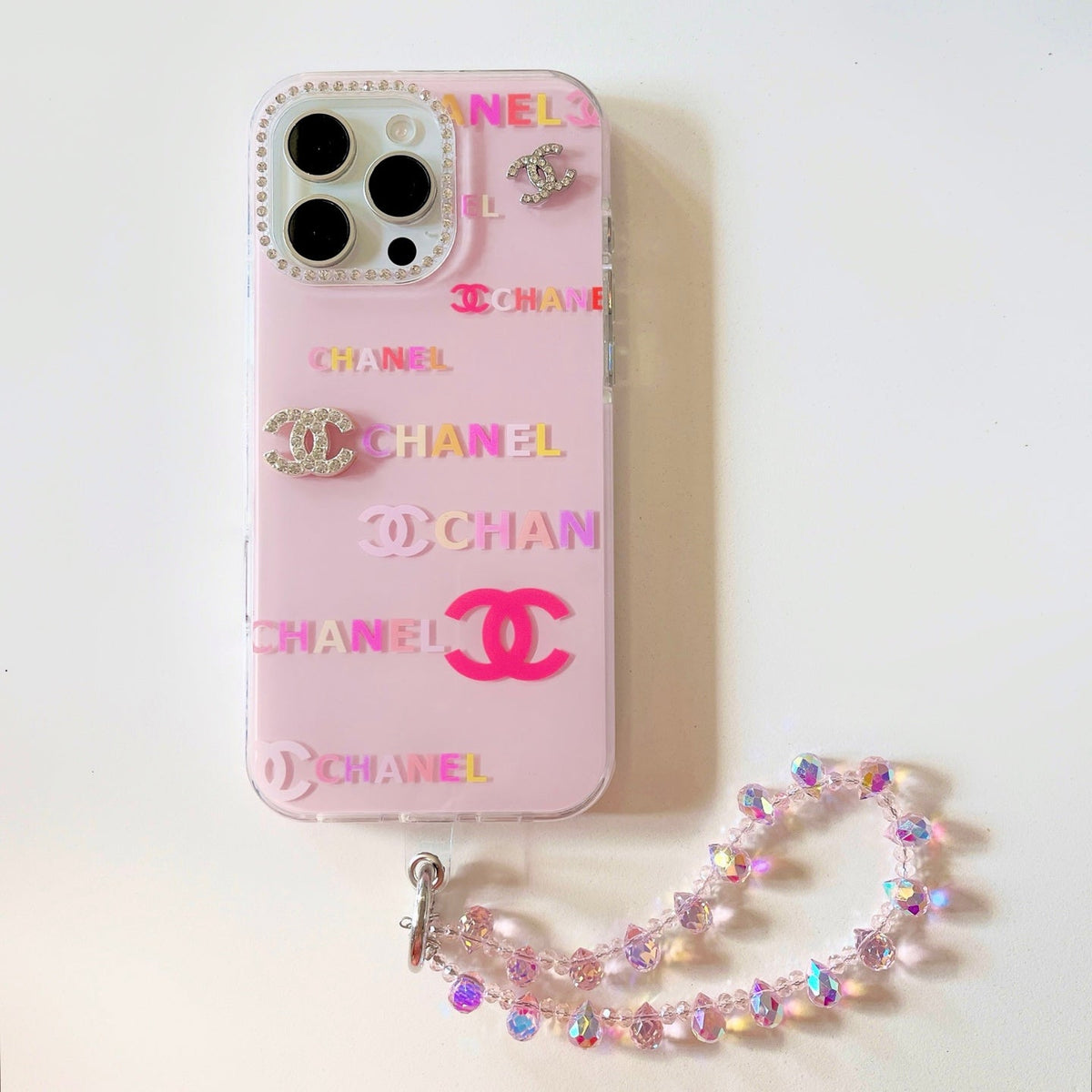 Cream and pink logo-print iPhone case with a beaded wrist strap