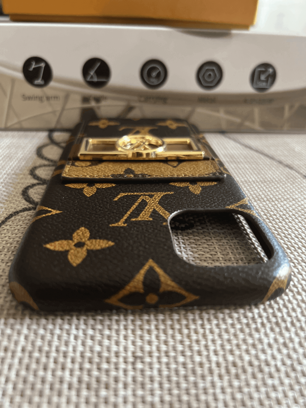 Monogram leather iPhone case showing the complete protective cover and patterned surface