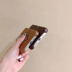 Detailed view of the brown single monogram iPhone case and its patterned back surface