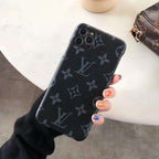 Classic leather iPhone case shown from the rear with the monogram-style pattern visible