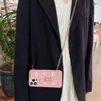 Pink soft canvas crossbody iPhone case showing the shoulder strap and textured rear cover