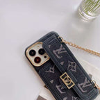 Black denim designer iPhone case close-up showing the woven fabric texture and camera opening