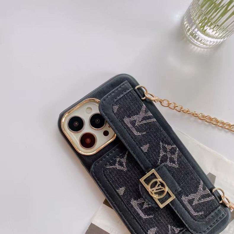 Black denim designer iPhone case close-up showing the woven fabric texture and camera opening