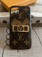 Monogram iPhone case shown from the back with protective corners and leather texture