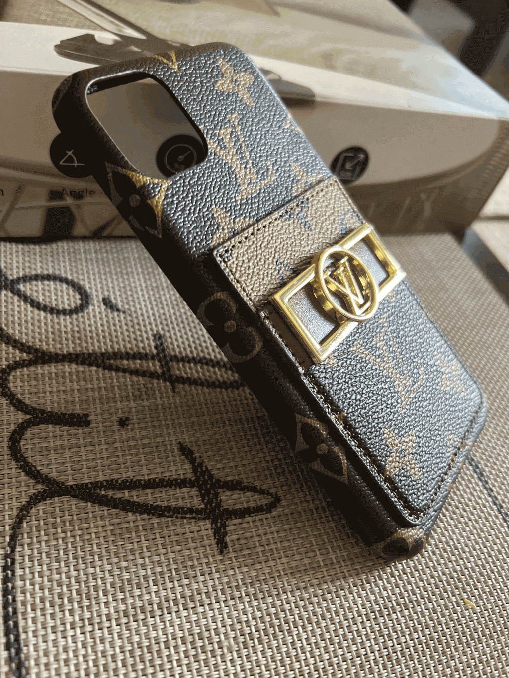 Detailed view of the monogram leather iPhone case showing the rear design and edge fit