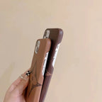 Close-up of the brown monogram iPhone case highlighting the leather pattern and finish