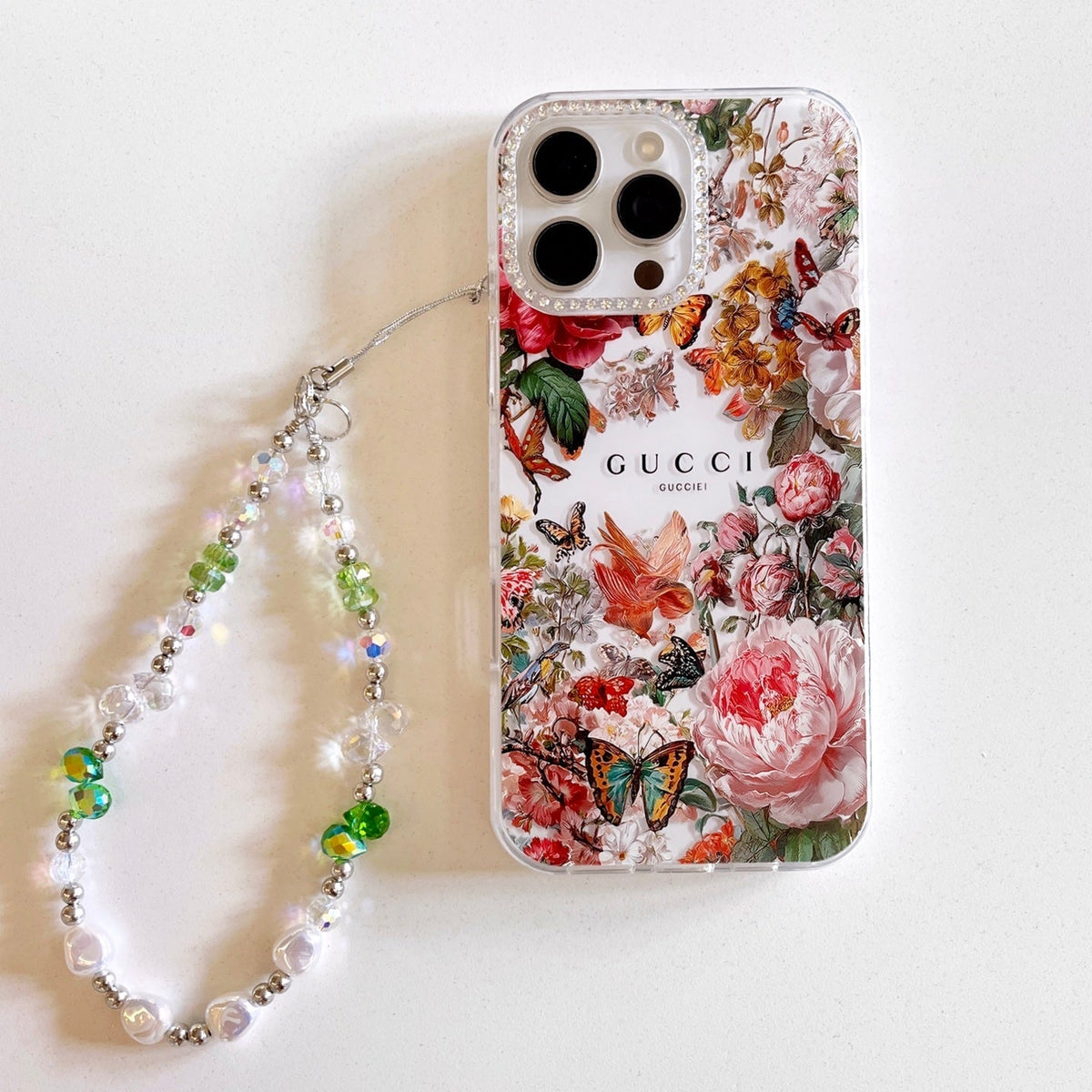 Red and pink floral iPhone case with a beaded wrist strap
