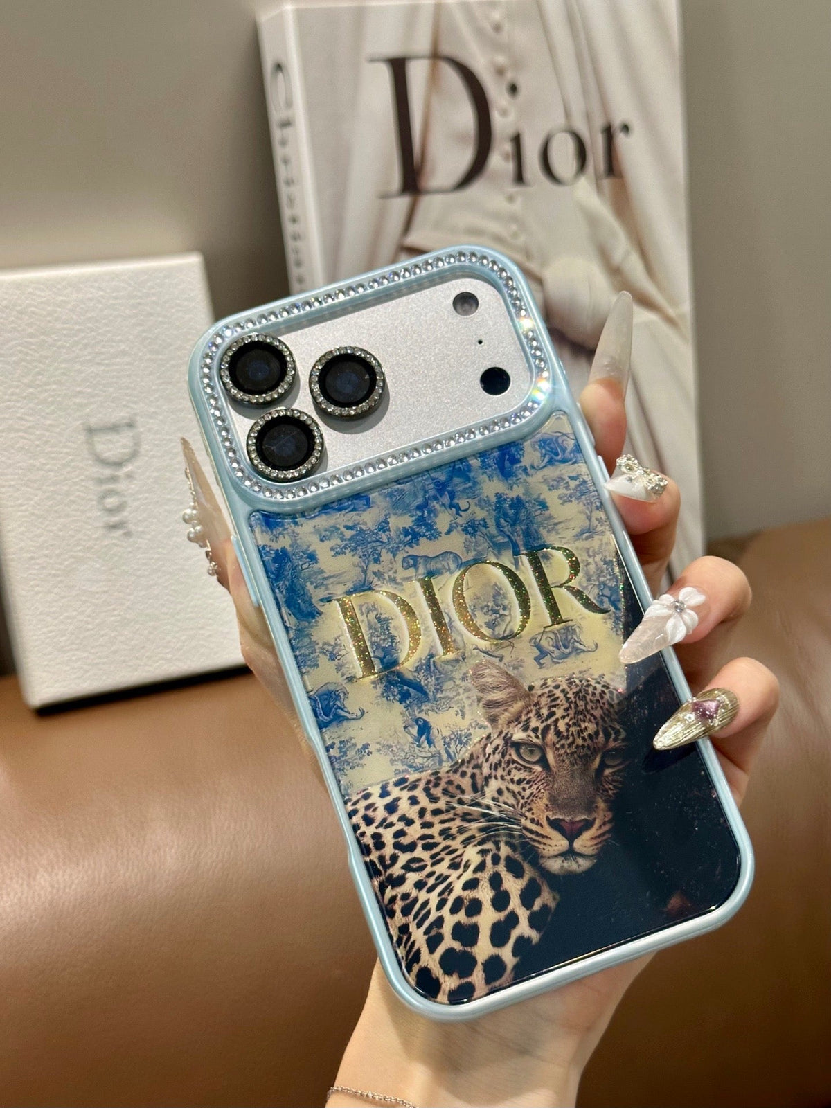 Blue and gold collage iPhone case with botanical and animal print details shown from another angle