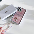 Pink patterned iPhone case with a central strap detail and beaded wristlet