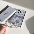 Blue and white monogram iPhone case with a jeweled frame and charm