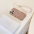 Blush monogram-print iPhone case with a beaded wrist strap in a close-up product view