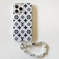 White and black high-contrast monogram iPhone case with a beaded wrist strap