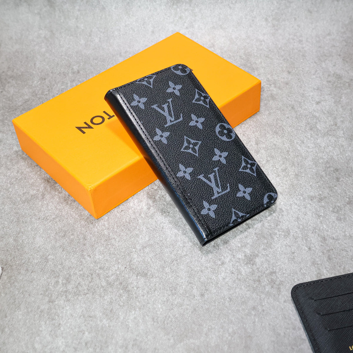 LV iPhone wallet case shown open with card slots and a slim protective phone shell