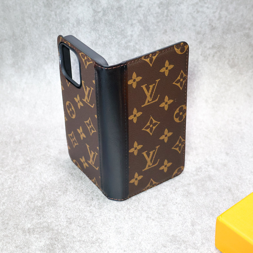 Detailed view of the LV wallet iPhone case showing the leather finish and protective edges