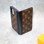 Detailed view of the LV wallet iPhone case showing the leather finish and protective edges