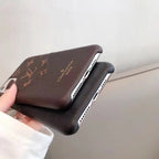 Louis Vuitton iPhone leather case showing clear access to the charging port and lower edge