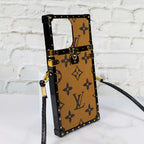 Designer trunk iPhone case showing the structured rear cover and reinforced protective edges