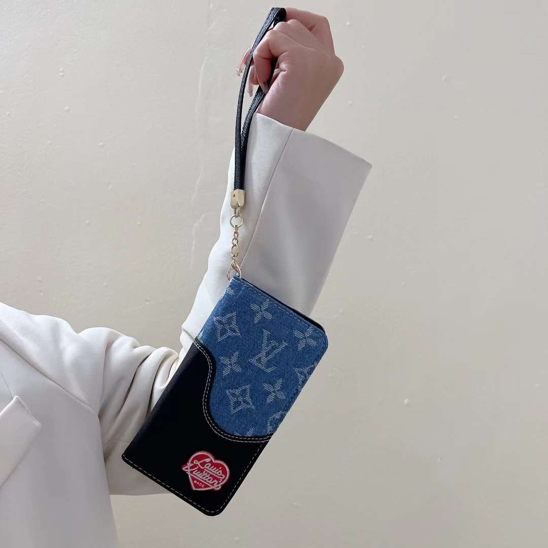 Blue denim leather iPhone wallet case shown in hand highlighting grip and everyday use