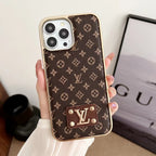Brown small monogram iPhone case showing the electroplated edge and patterned leather back