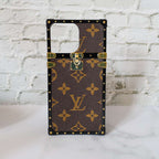 Reverse monogram Eye Trunk iPhone case front view showing the structured trunk-style design