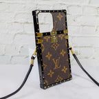 Reverse monogram Eye Trunk iPhone case left side view showing the reinforced edge profile