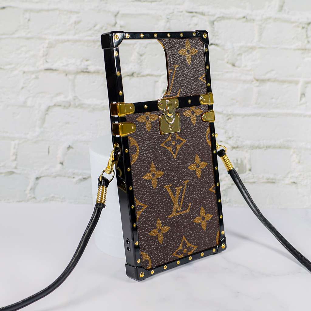 Reverse monogram Eye Trunk iPhone case left side view showing the reinforced edge profile