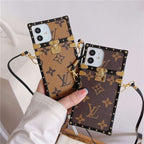 LV trunk iPhone case showing the reinforced back design and decorative hardware