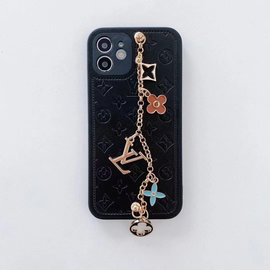 Black LV ornament iPhone case showing the leather back, camera opening and decorative strap